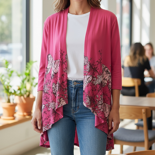 Woman wearing a pink patterned cardigan in a cafe setting